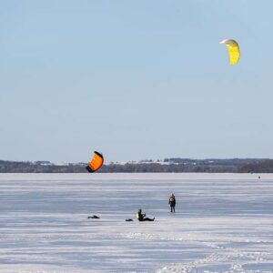 People flying kites over a frozen Lake Mendota
